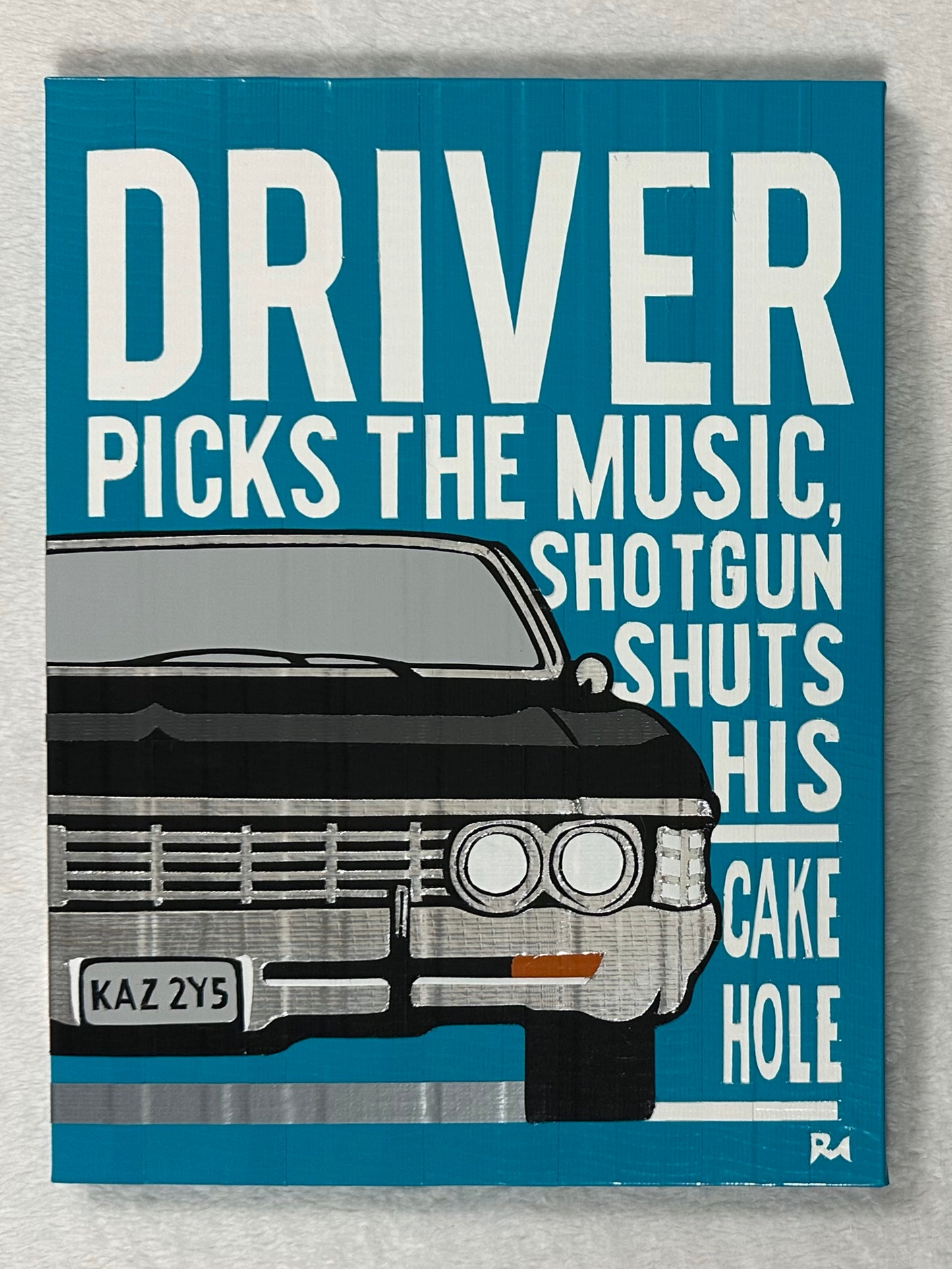 A blue, black, and white poster on a white background. The poster depicts the front side of a 1967 Impala, with white text saying "driver picks the music, shotgun shuts his cake hole." The poster is created with duct tape.
