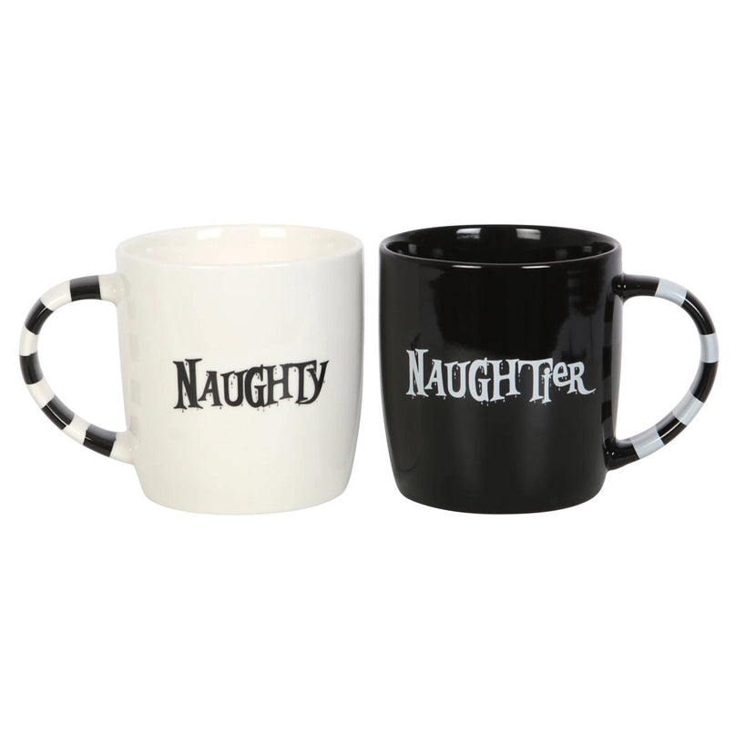 A pair of mugs on a white background. The left mug is white with black stripes on the handle. Black text on the mug's center says "naughty." The right mug is black with white stripes on the handle. White text on the mug's center says "naughtier."