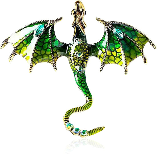Close up view of a dragon-shaped brooch against a white background. The dragon is green with gold accents, and has green rhinestones inset in its tail and abdomen. The dragon's wings are spread out to the side, and its head is pointed straight out.
