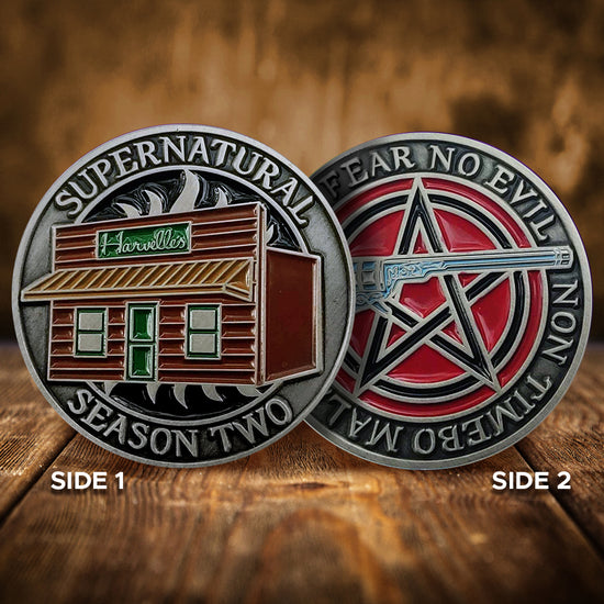 A brass coin with "Supernatural season two" over an anti-possession symbol with a storefront that reads "Harwelle's" on it on one side and "I will fear no evil - Non timebo mala" with the Colt pistol over a pentagram on the other