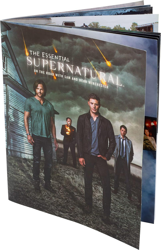 A softcover book on a white background. On the cover is a picture of characters from the TV series Supernatural, standing next to a white house.