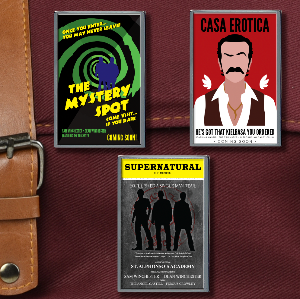 Three enamel pins on a maroon canvas bag. The top left pin depicts a green and black swirl, with "Mystery Spot" in yellow letters. The top right depicts a mustached man in a white shirt against a red background. Black text says "casa erotica." The bottom pin has Dean, Sam, and Castiel in silhouette against a grey background. At the top is a yellow banner with black text saying "Supernatural the musical."