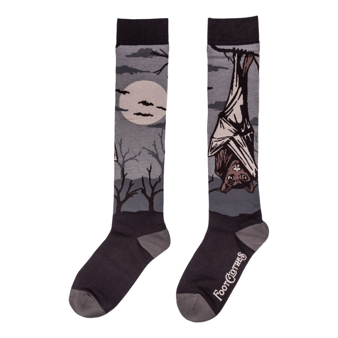 Pair of socks with a bat and moon design on a white background