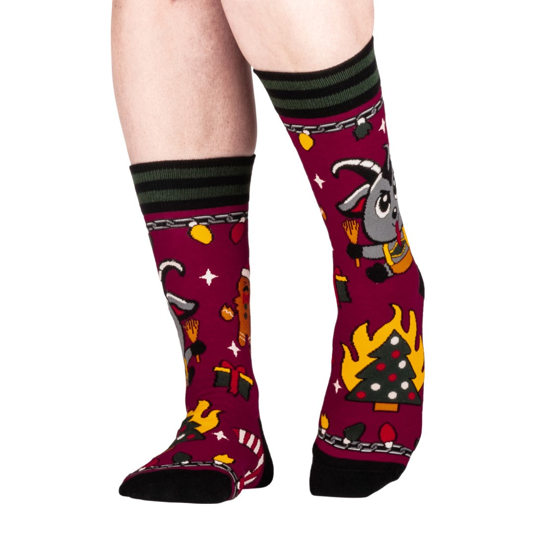 Colorful socks with cartoon Krampus design on a white background