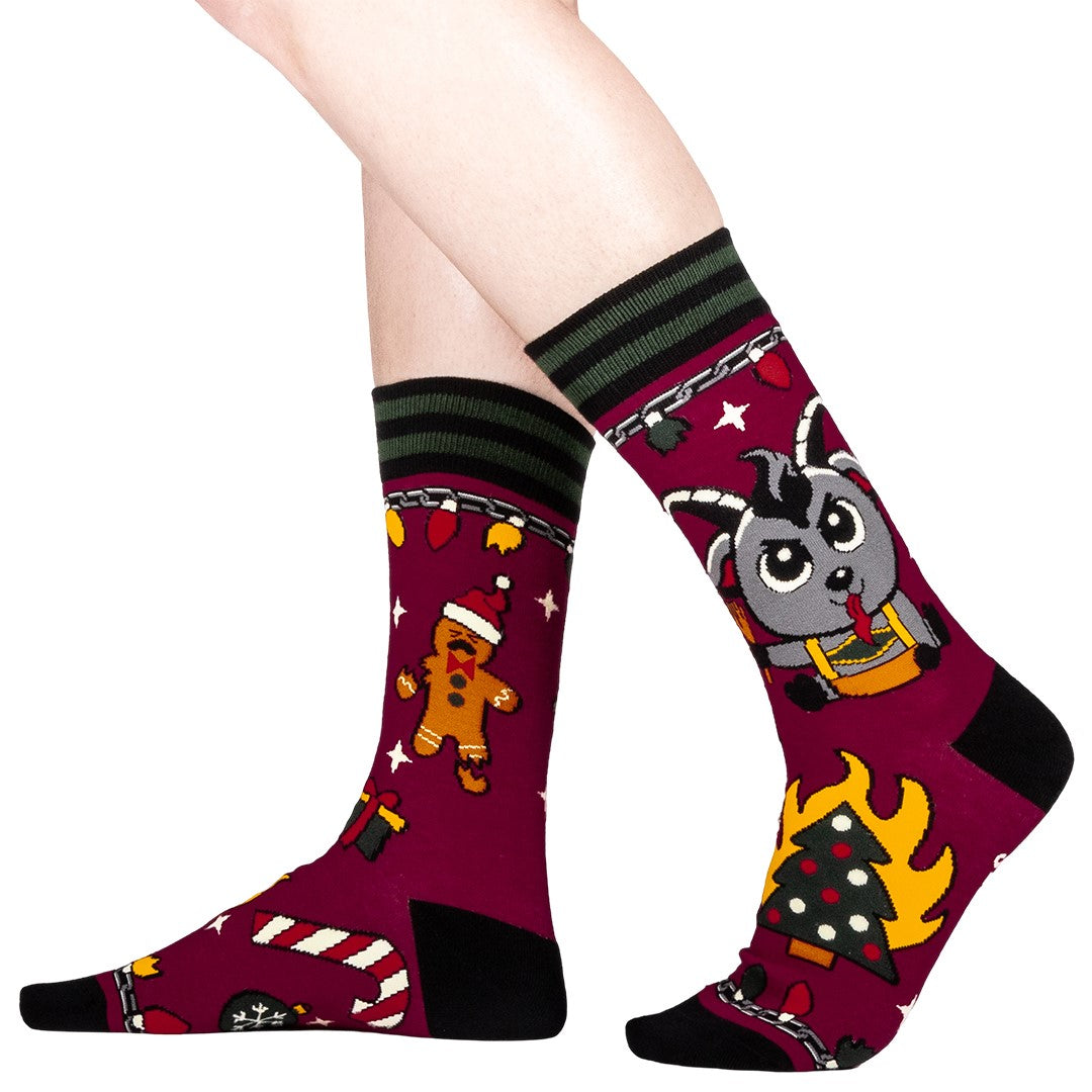 Colorful socks with cartoon Krampus design on a white background