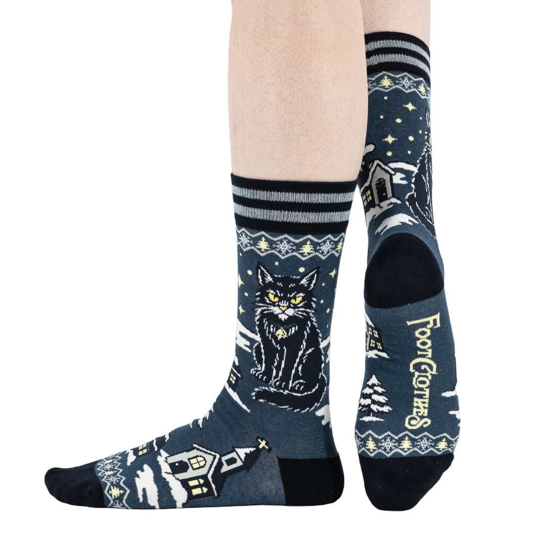 Cat-themed socks with house design on a white background