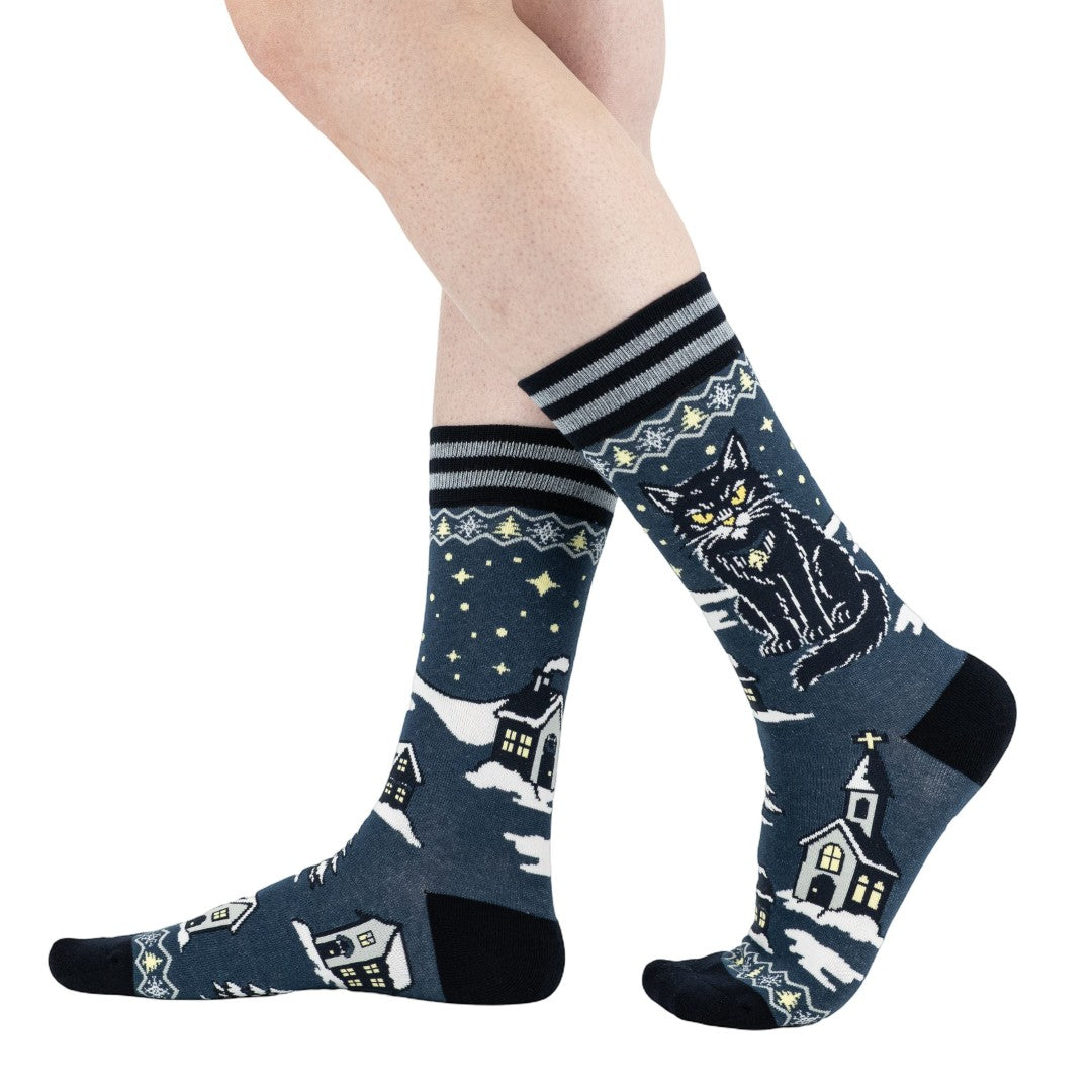 Patterned socks with night sky design featuring stars and houses on a white background