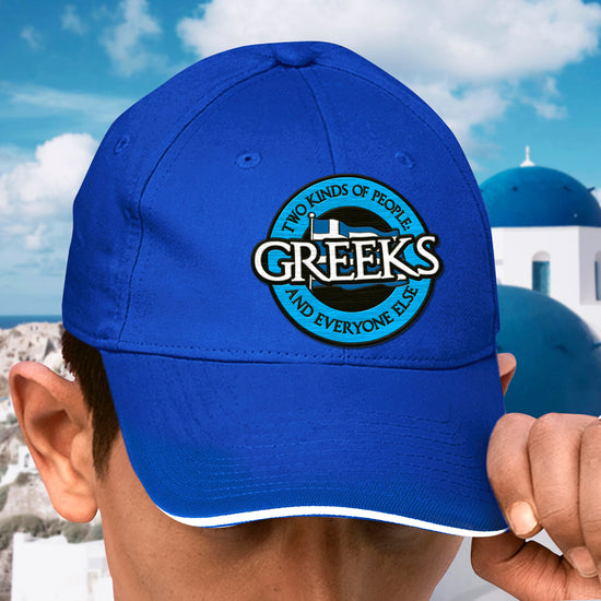 A model wearing a blue hat with a blue and white logo. The logo says "two kinds of people, greeks and everyone else."