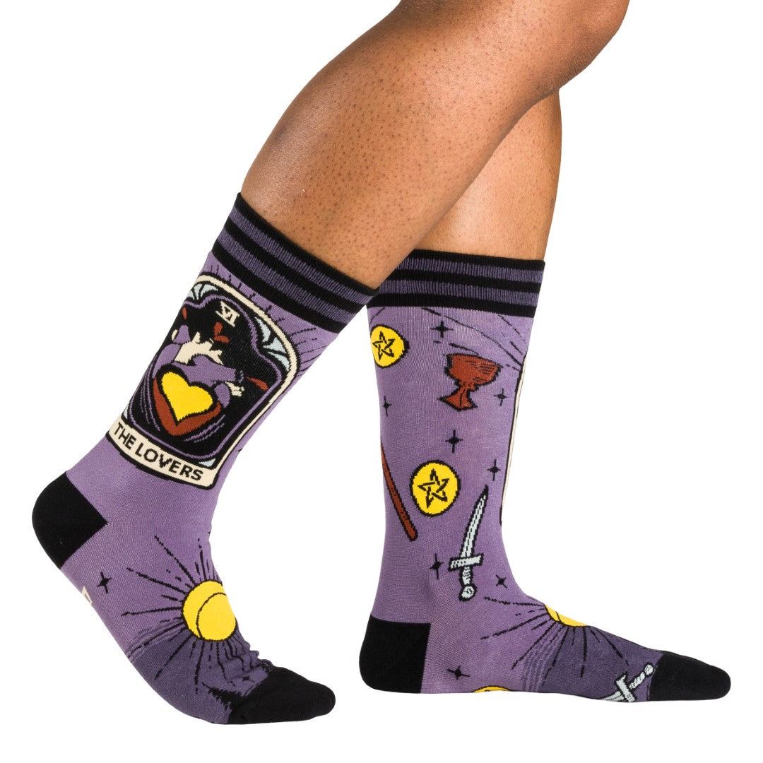 Purple socks with tarot card design worn by a person on a white background