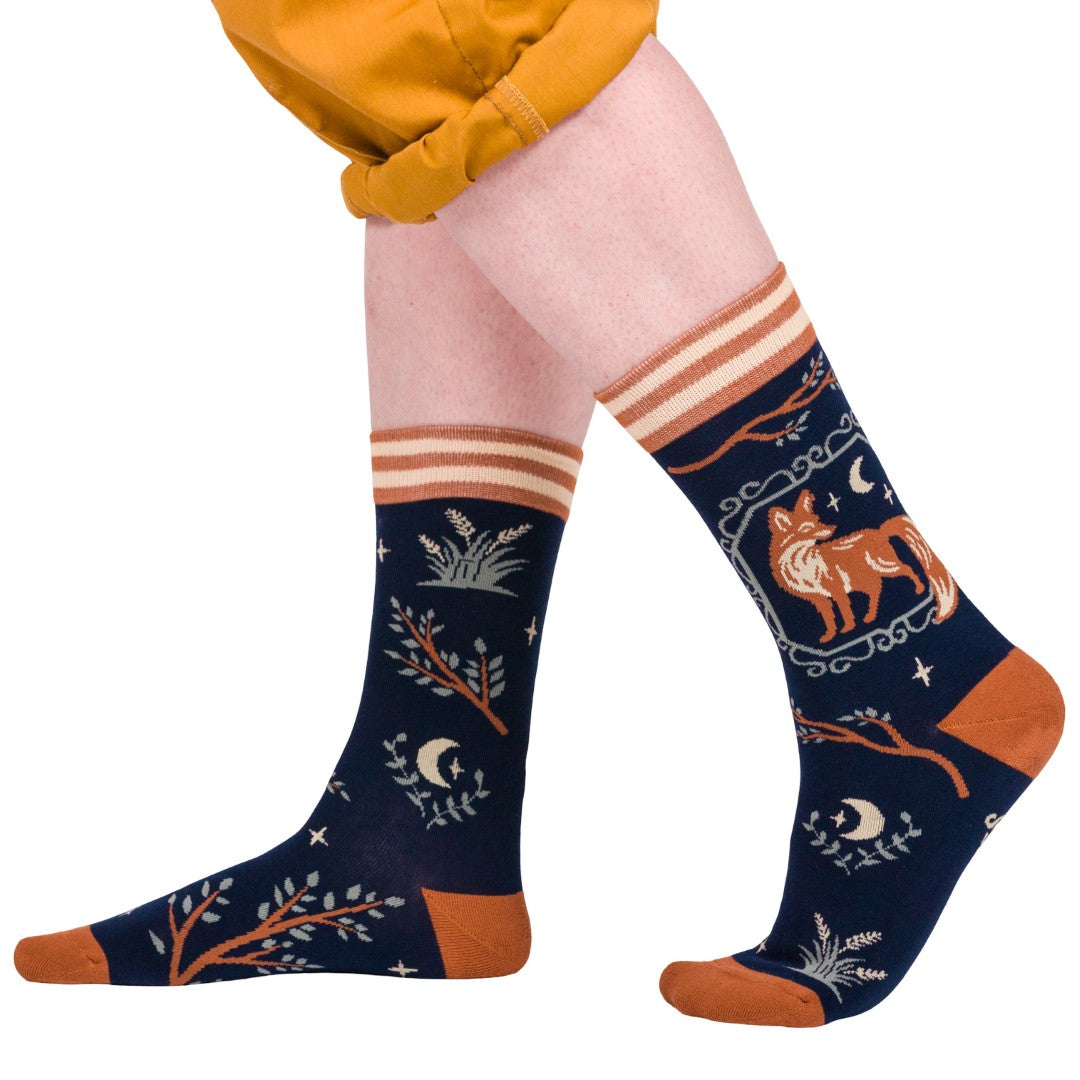 Navy blue socks with orange and white patterns worn by a person on a white background