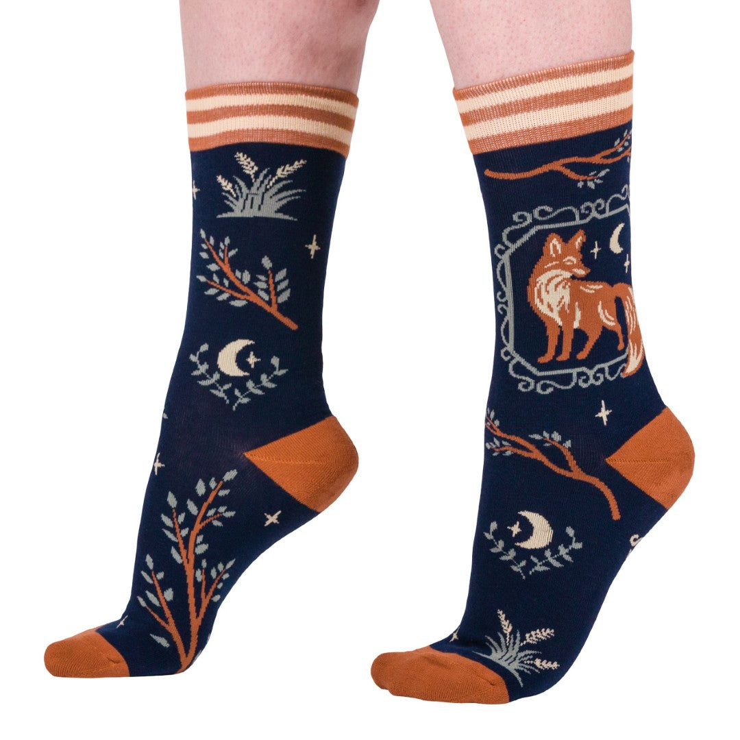 Navy blue socks with fox and moon design on a white background