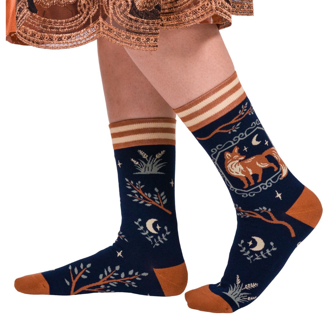 Navy blue socks with brown and beige patterns worn by a person on a white background