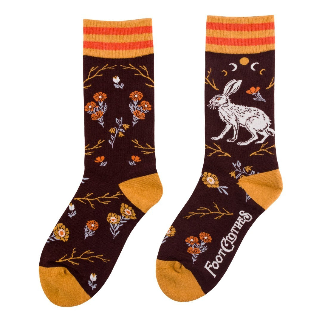 Pair of socks with floral and animal design on a white background