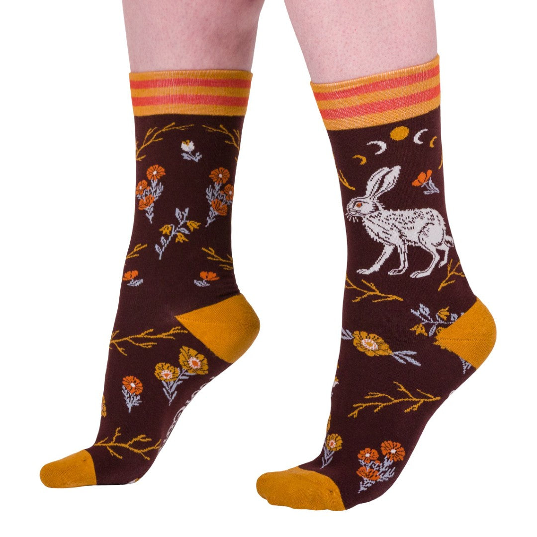 Pair of socks with rabbit and floral design on a white background