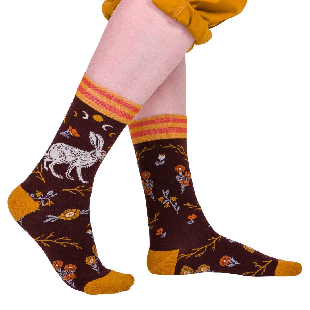 Patterned socks with floral and animal designs on a white background