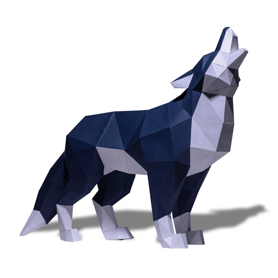 A blue and white paper model of a howling wolf, on a white background.