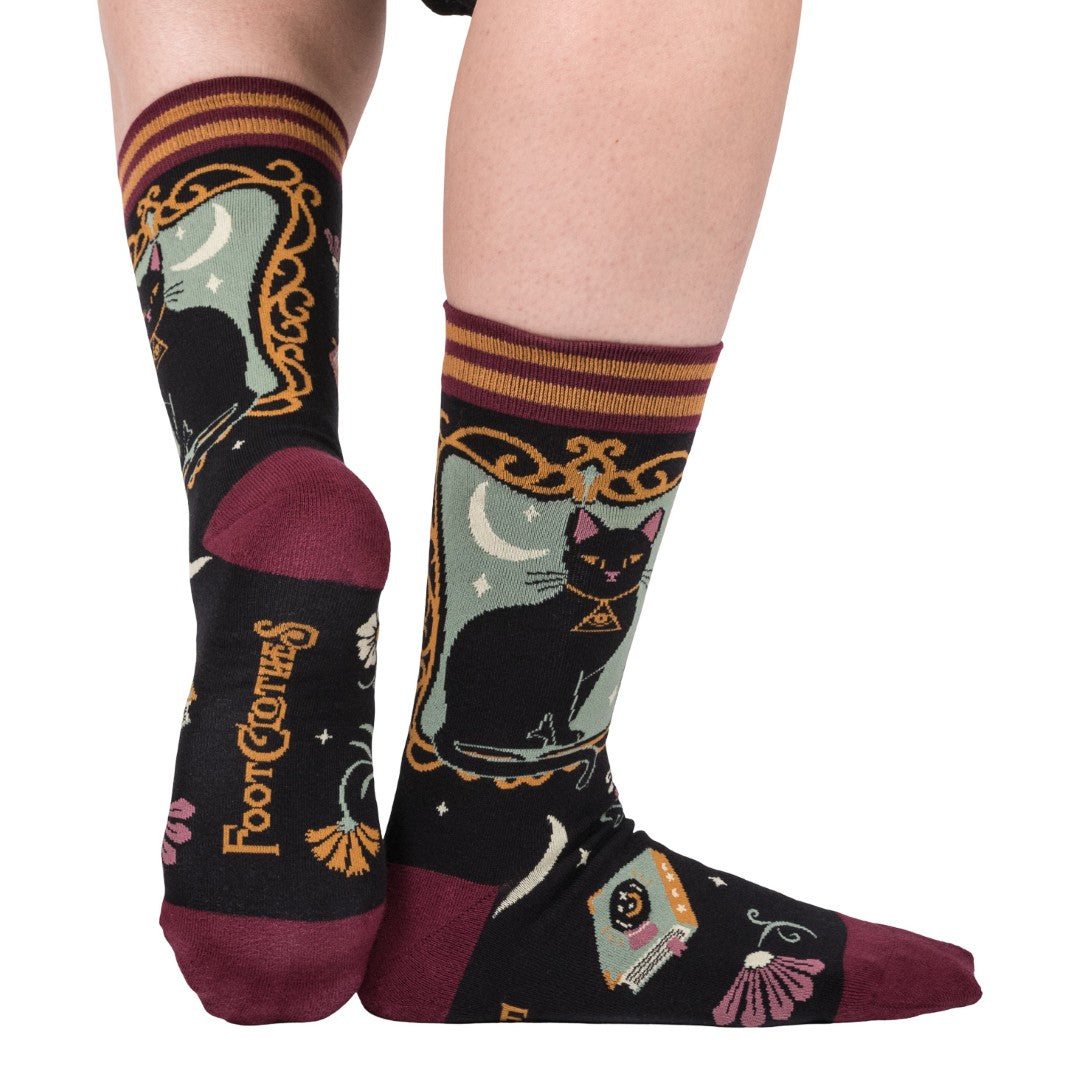 Pair of socks with cat and moon design on a white background