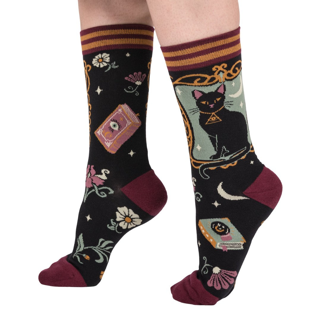 Colorful socks with cat and book design on a white background