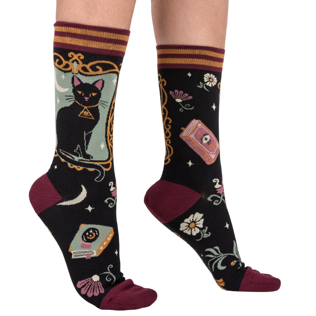 Decorative socks with a black cat design on a white background