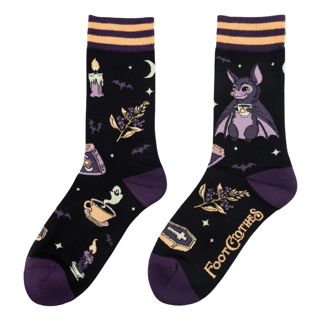 Pair of socks with Halloween-themed designs on a white background