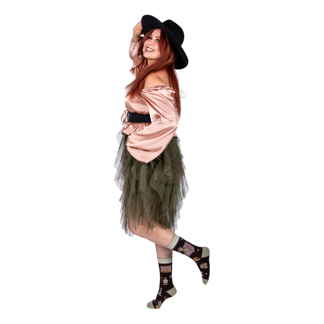 Person wearing a costume with a hat, dress, and socks on a white background