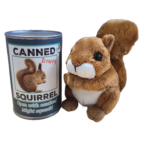 A squirrel plushie next to a blue can. The front of the can has a picture of a squirrel, with black and light blue text that says "canned squirrel. Open with caution! Might squeak!"