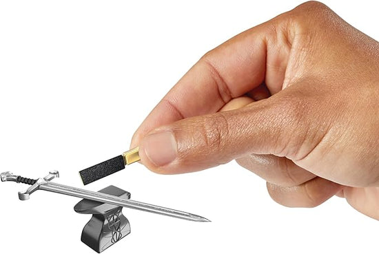 A miniature replica of a sword from The Lord of the Rings. A model's hand is holding a small sharpening stone.