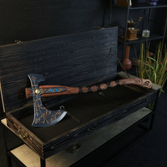 A wooden axe, styled after the one used by Kratos in the "God of War" video games, in a wooden case. The blade has runes inscribed in the flat edge.