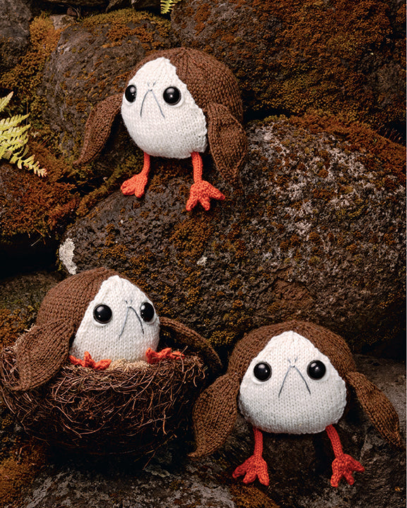 Three knitted porg dolls on a textured brown background