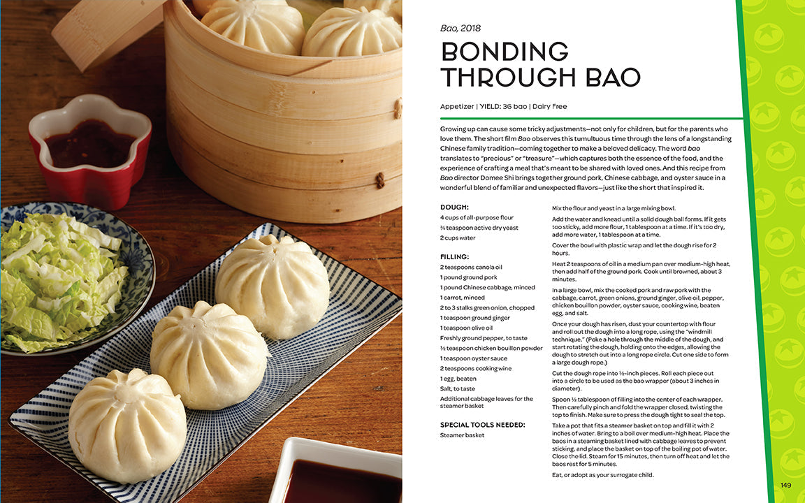 Steamed buns on a tray with a bowl of green relish and a small container of red sauce on a wooden table.