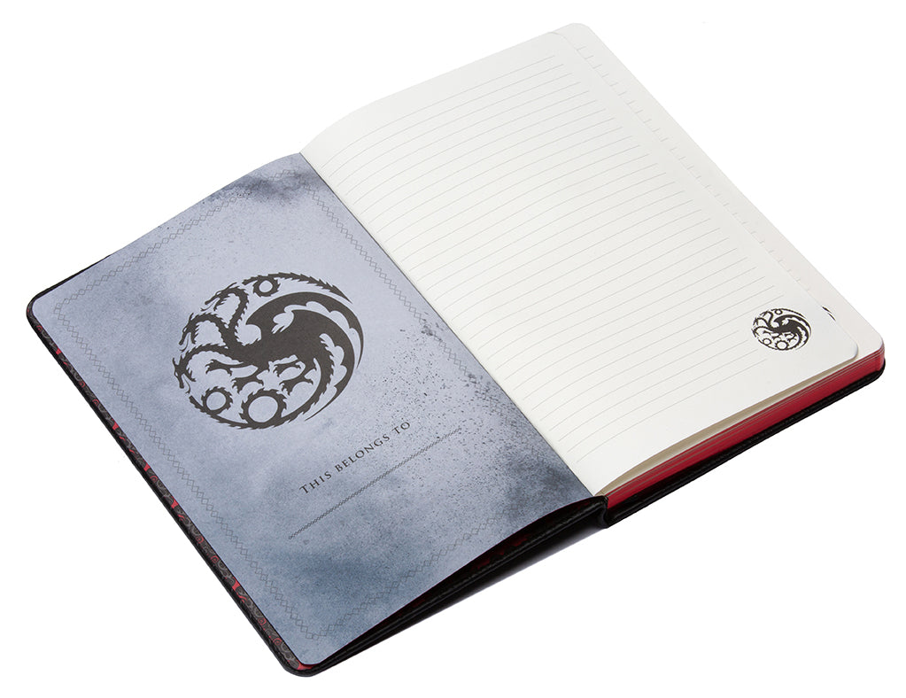 Open notebook with a dragon emblem on the cover and white pages.