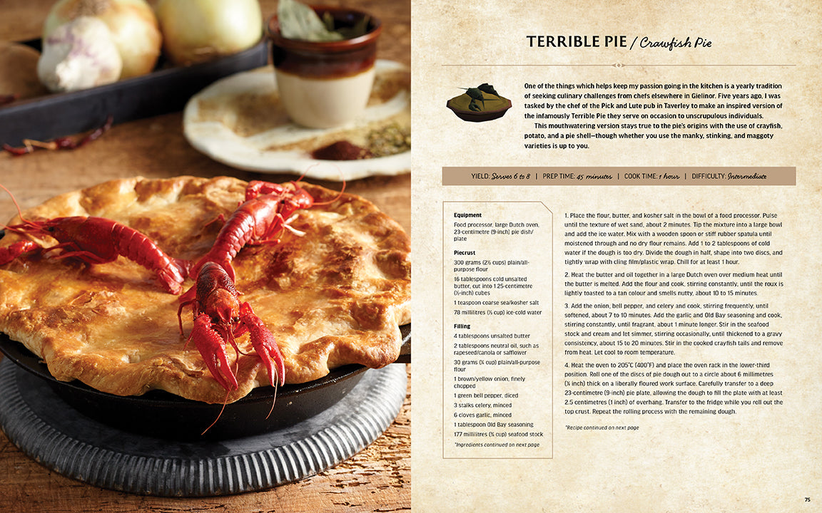 Pie with crawfish on a wooden table next to a recipe card.