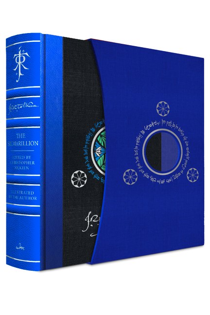 A bright blue hardcover book with a matching foiled slipcase. The book has raised spine edges and silver-foiled text on the spine, as well as JRR Tolkien's signature printed on the black front cover.
