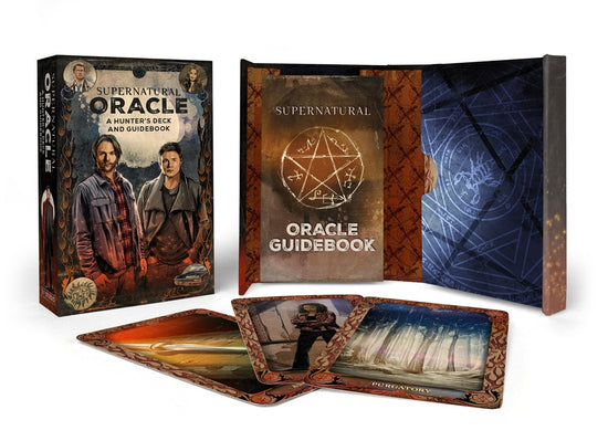 A box of oracle cards labeled "Supernatural Oracle: A Hunter's Deck and Guidebook". The box has an illustration of Sam and Dean in the front-center, and smaller illustrations of Castiel, Meg, an anti-possession tattoo, and the Impala in the corners. The inside has a sigil pattern and contains an Oracle Guidebook. Example cards for an Angel Blade and Purgatory are in front of the box.