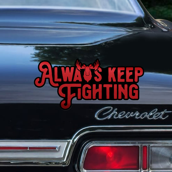 Black Chevrolet car with 'Always Keep Fighting' decal on the trunk