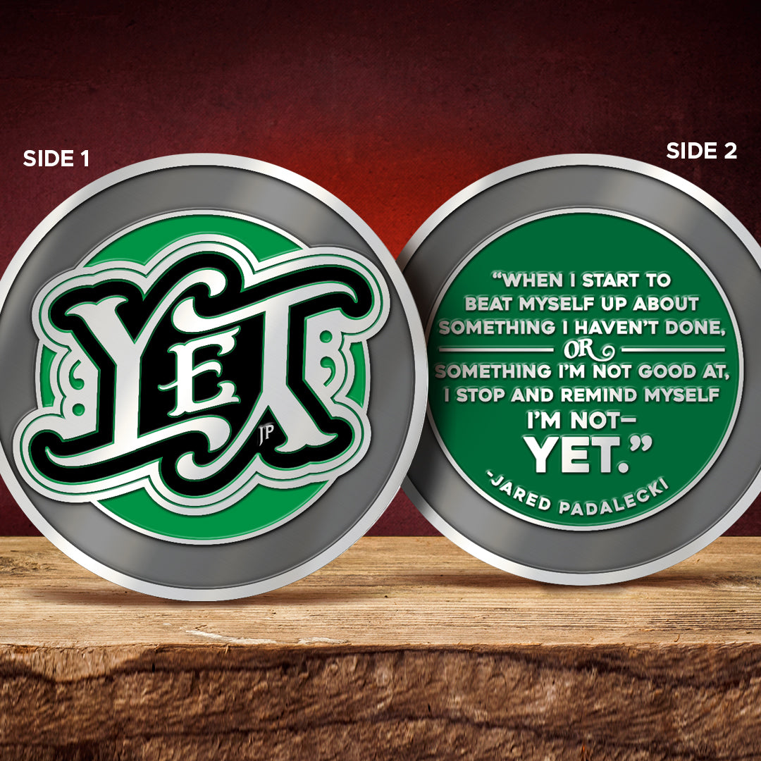 Back and front images of a green and black challenge  coin, featuring "YET" on the front and quote from Jared Padalecki on the back