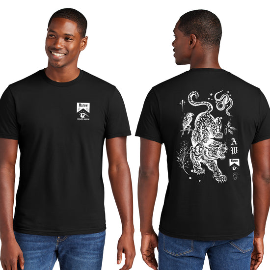 Front and back views of a male model in a black unisex t-shirt. The front has a small design in the upper-right that reads 'Marow' and 'Amazon Watch' in a style reminiscent of a cigarette box. The back has a full-back print of a large leopard surrounded by icons of a bird, leaves, snake, a simple skull, and other small/simple icons.