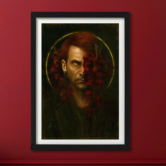 A framed lithograph against a red wall depicting the character Crowley from "Good Omens." Across his face are dark red flowers.
