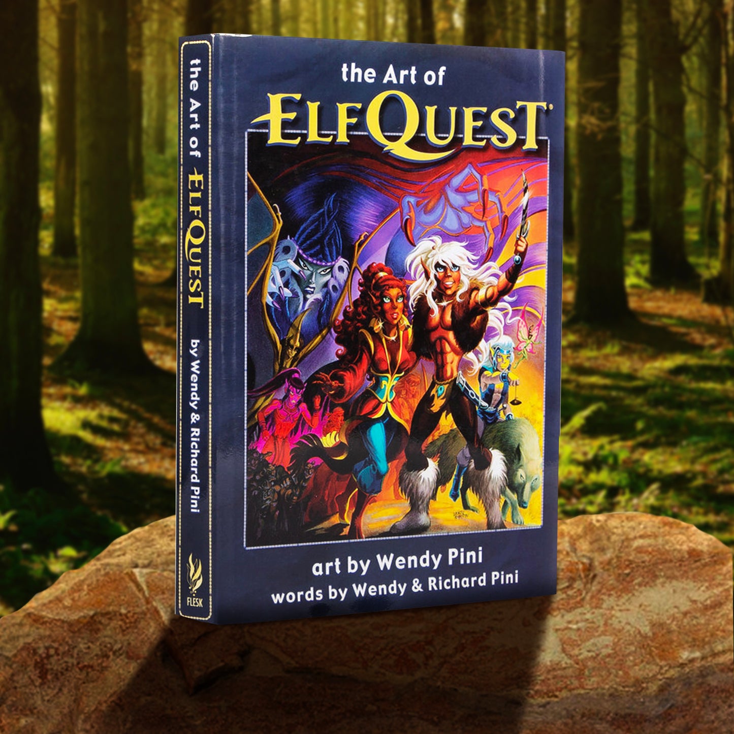 A copy of "The Art of ElfQuest: art by Wendy Pini, words by Wendy & Richard Pini" depicted in a forest setting. The cover is a dark purple-blue and features ElfQuest characters on the front. 