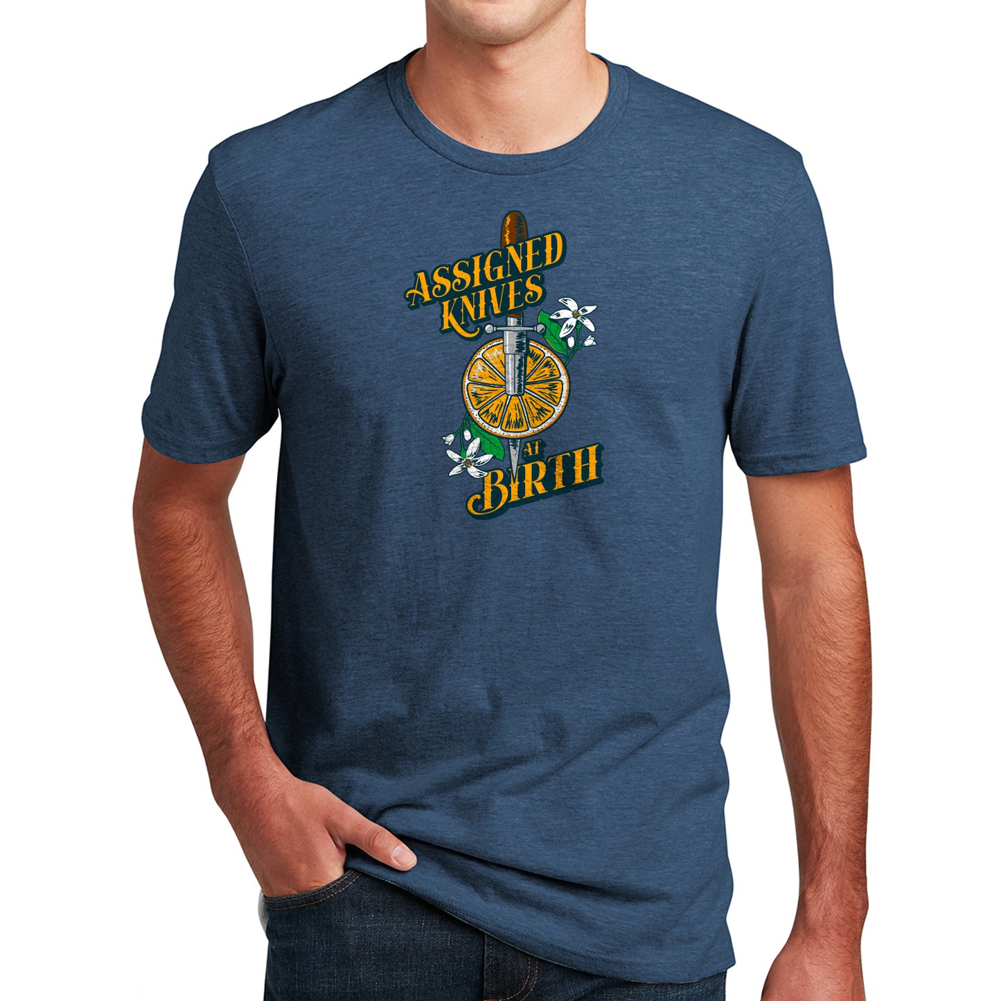 Load image into Gallery viewer, An image of a man wearing a navy heathered T-shirt bearing the inscription: Assigned Knives at Birth.&amp;quot; The design features a knife and an orange.
