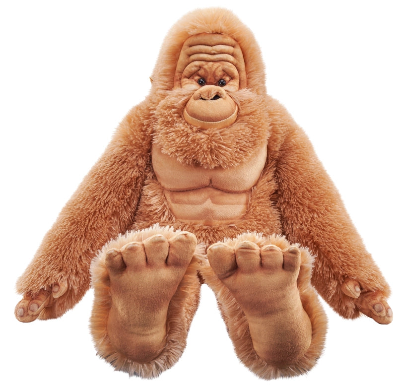 Load image into Gallery viewer, Close up view of a stuffed Bigfoot doll, against a white background. The doll has reddish hair, with a light brown wrinkled face and very large brown feet.

