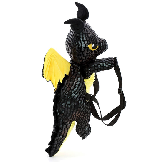 A black and yellow backpack against a white background. The backpack is shaped like a dragon with black straps. The dragon's eyes, belly, and wings are yellow.