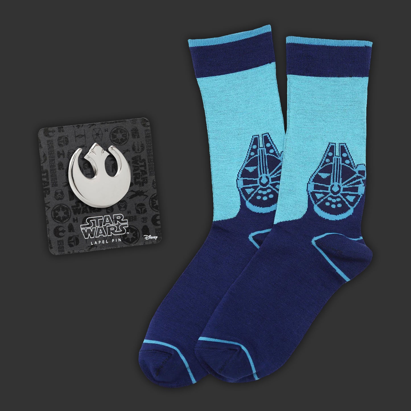 Blue socks with Millennium Falcon design and Rebel Alliance logo label pin on a dark background
