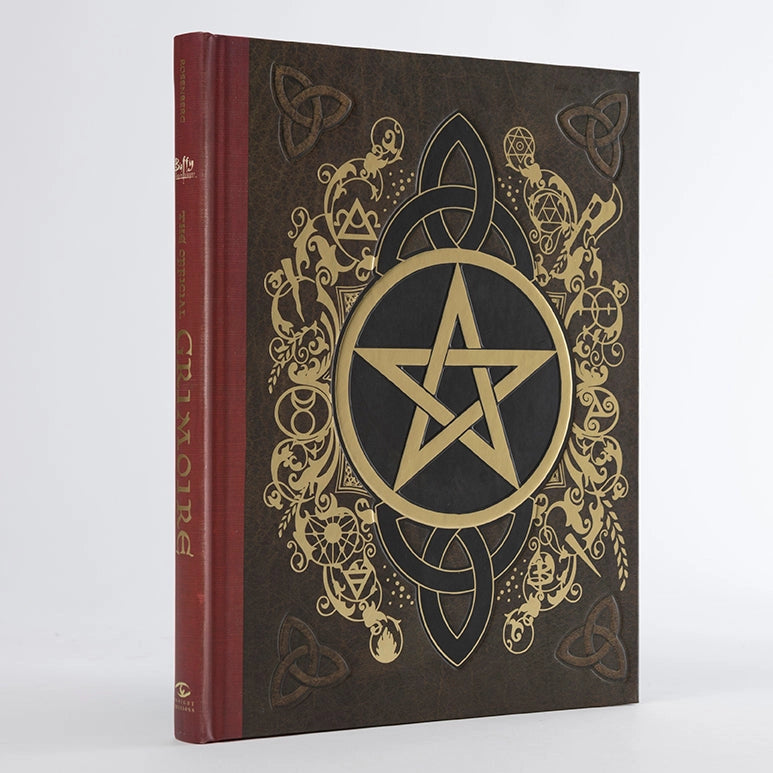 A hardcover book with a gold and black pentagram on the front cover.