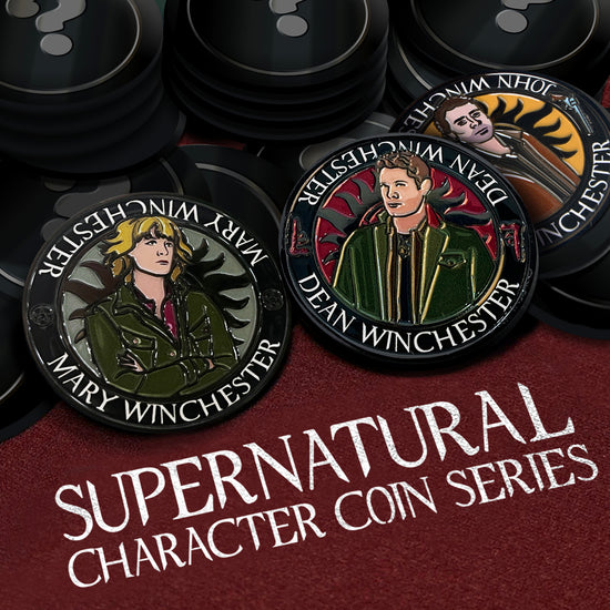 A pile of coins on a maroon table top. One of the coins depicts a drawing of Dean Winchester, wearing a green jacket and black shirt. One coin depicts a drawing of Mary Winchester wearing a green jacket and a red shirt. One coin depicts a drawing of John Winchester wearing a brown jacket and black shirt. Behind them is the edge of the anti-possession symbol. The other coins are black with a grey question mark in their center. At the bottom is white text that says "Supernatural character coin series."