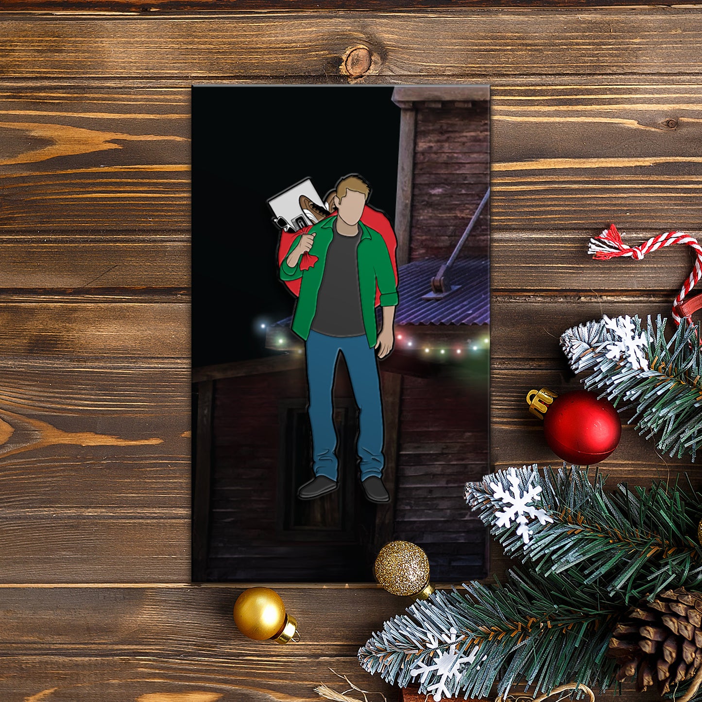 An enamel pin depicting Dean Winchester carrying a sack of Christmas gifts in a red bag