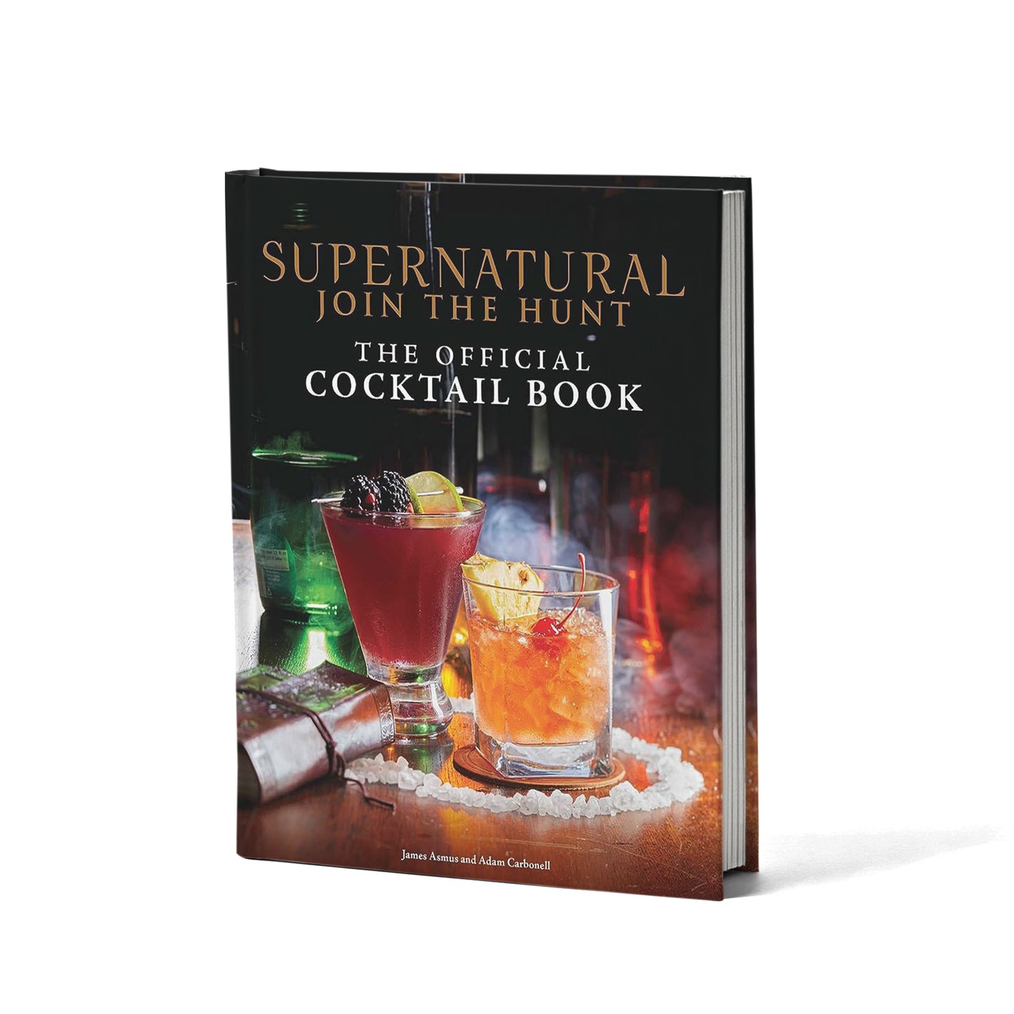 A picture of various cocktails on a tabletop, sitting in a circle of salt crystals. At the top is gold text reading "Supernatural, Join the hunt." Below that in white text is "The official Cocktail Book."