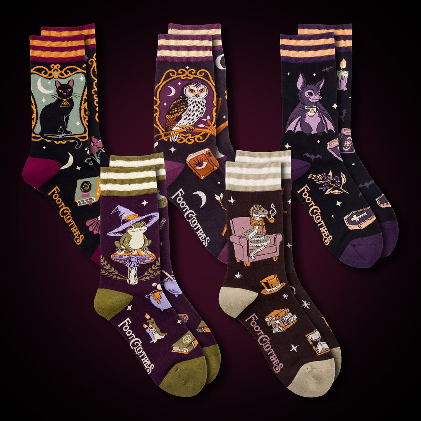 Five pairs of socks against a dark purple background. Each pair depicts a whimsical animal, with various witchy-themed items in a pattern.