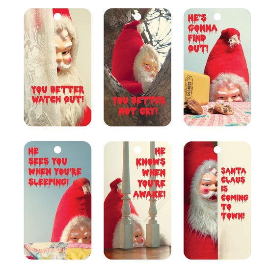 Six rectangular gift tags in two rows. Each depicts a creepy image of Santa Claus, with red text at the bottom, stylized to look like it's dripping.