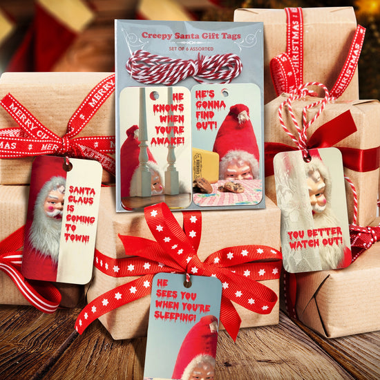 Creepy Santa gift tags on wrapped gifts with red ribbons